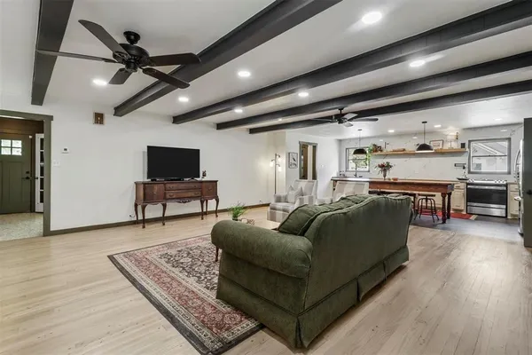 a living room with furniture and a wooden floor