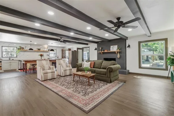 a living room with furniture and wooden floor