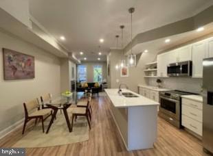 a large kitchen with a table and chairs