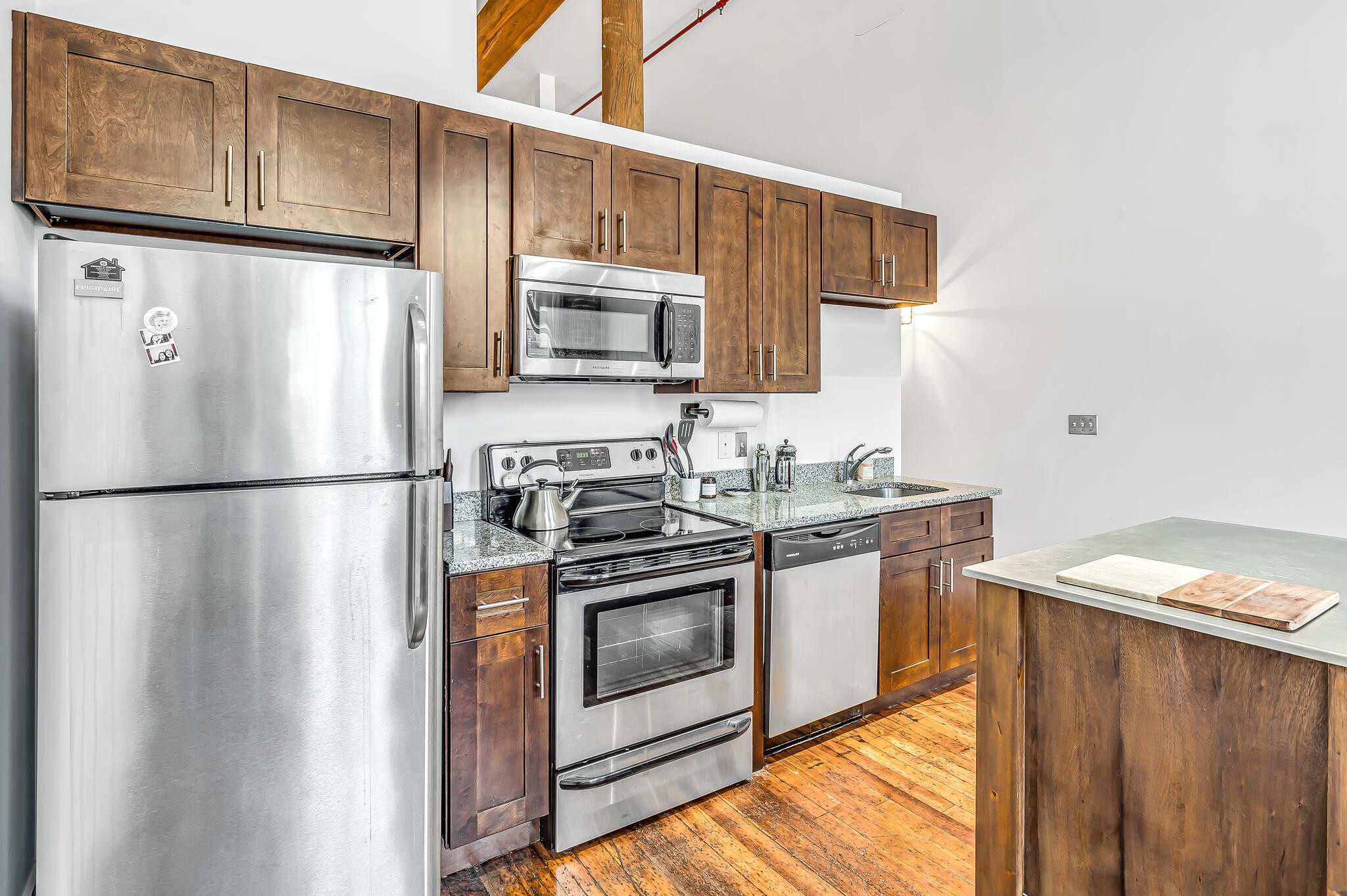 1350 Rosa L Parks Boulevard, Unit 338 Nashville, TN 37208 - Photo 13 of 28 a kitchen with stainless steel appliances granite countertop a refrigerator a stove a sink and a microwave
