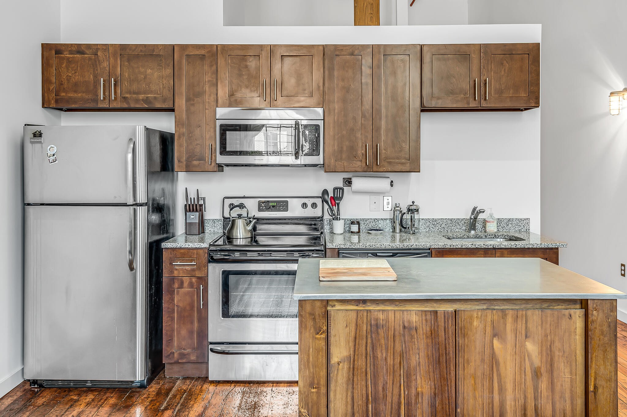 1350 Rosa L Parks Boulevard, Unit 338 Nashville, TN 37208 - Photo 14 of 28 a kitchen with stainless steel appliances granite countertop a refrigerator a stove a sink and a white cabinets