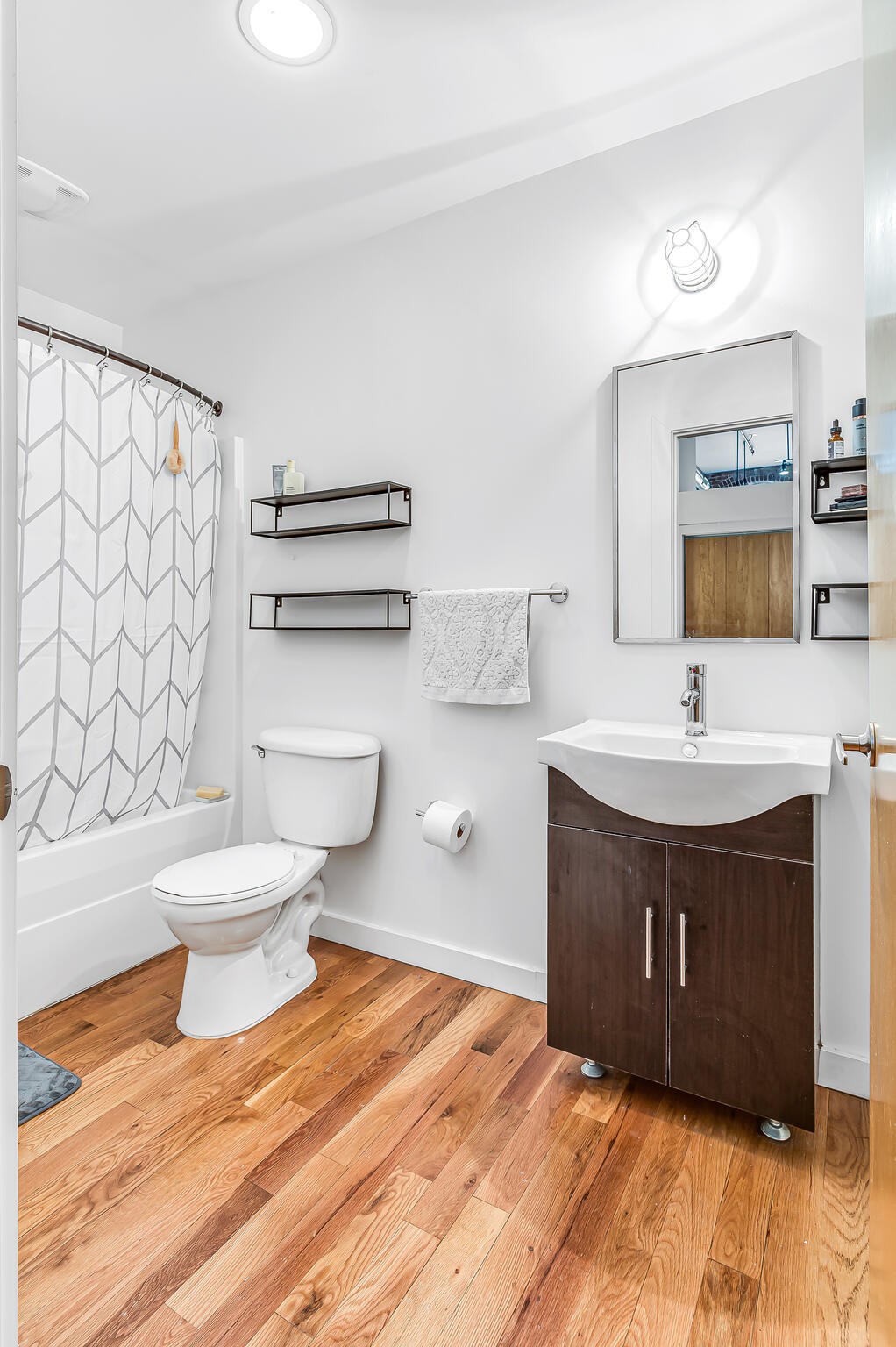 1350 Rosa L Parks Boulevard, Unit 338 Nashville, TN 37208 - Photo 18 of 28 a bathroom with a sink vanity mirror and toilet
