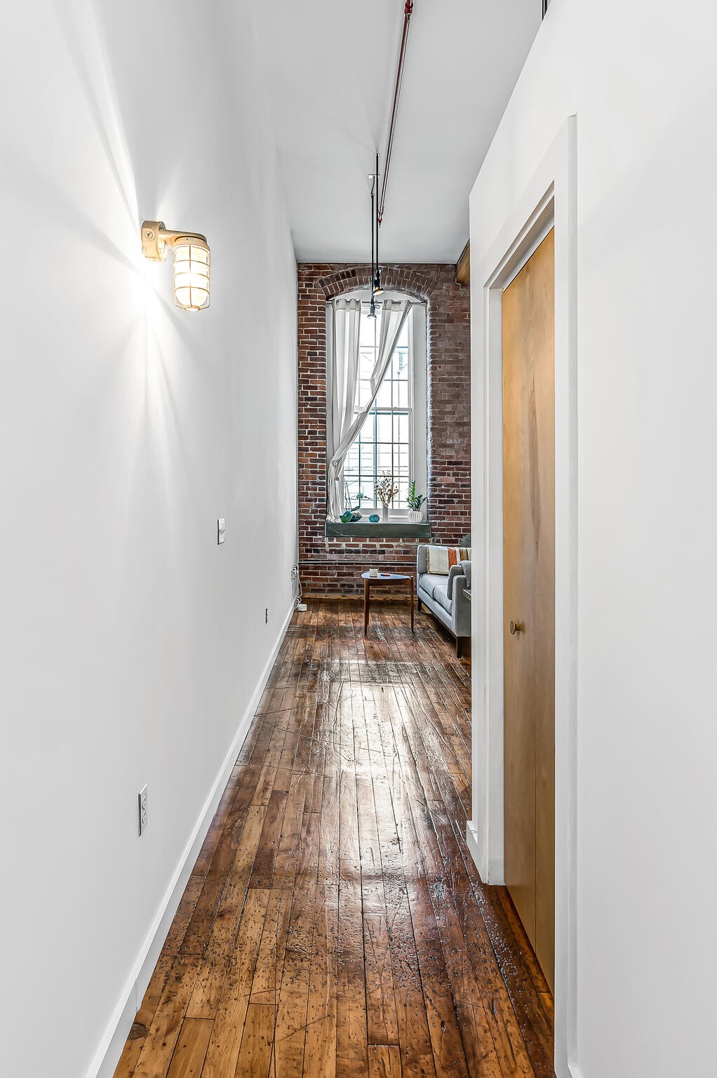 1350 Rosa L Parks Boulevard, Unit 338 Nashville, TN 37208 - Photo 5 of 28 a view of a hallway with wooden floor and a bathroom