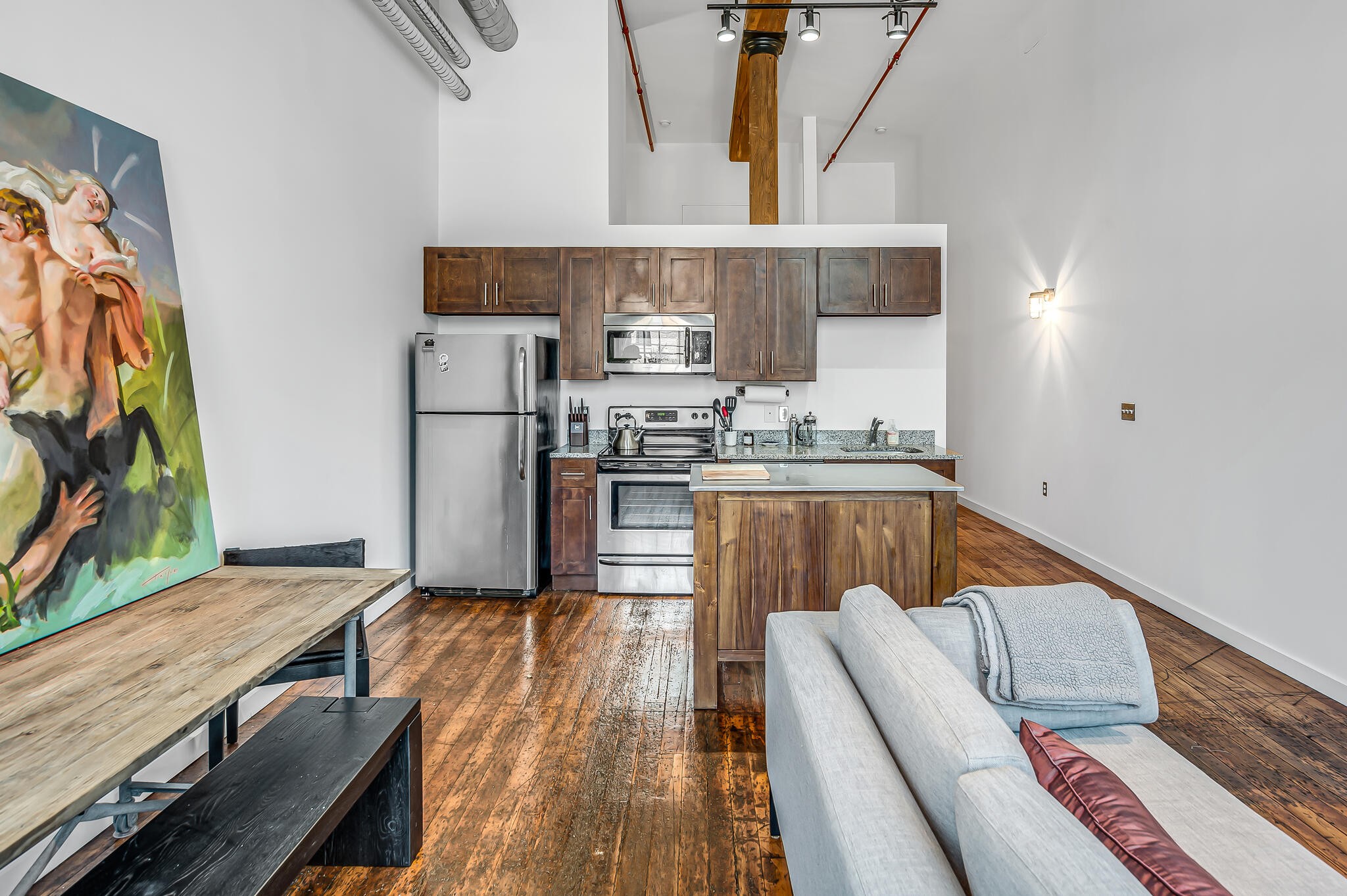 1350 Rosa L Parks Boulevard, Unit 338 Nashville, TN 37208 - Photo 10 of 28 a kitchen with kitchen island a large counter top space a sink stainless steel appliances and cabinets