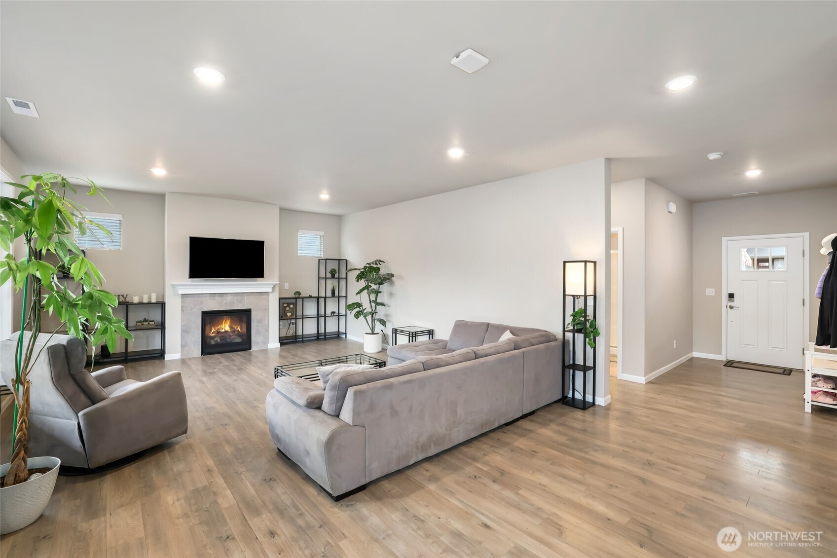25704 207th Place Southeast Covington, WA 98042 - Photo 2 of 34 a living room with fireplace furniture and a flat screen tv