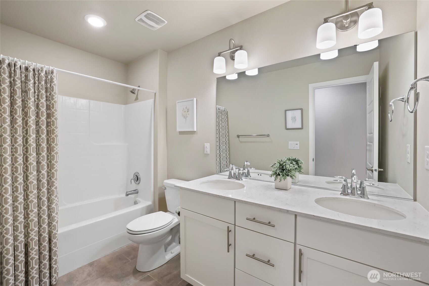 25704 207th Place Southeast Covington, WA 98042 - Photo 22 of 34 a bathroom with a toilet a sink a mirror a bathtub and vanity