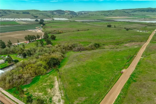 a view of a field with an ocean view