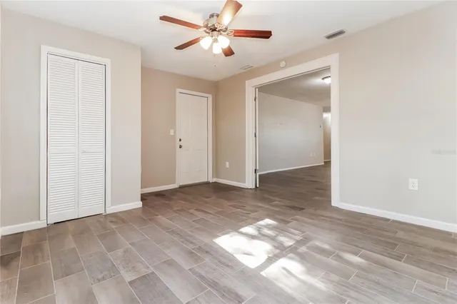 a view of a hallway with a chandelier fan