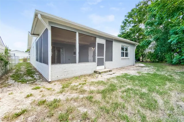 a view of a house with a yard and potted plants