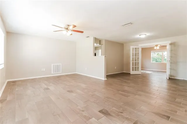 wooden floor in an empty room with a window