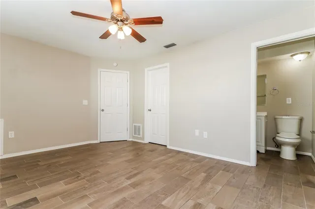 a view of a room with a stylish ceiling fan and entryway