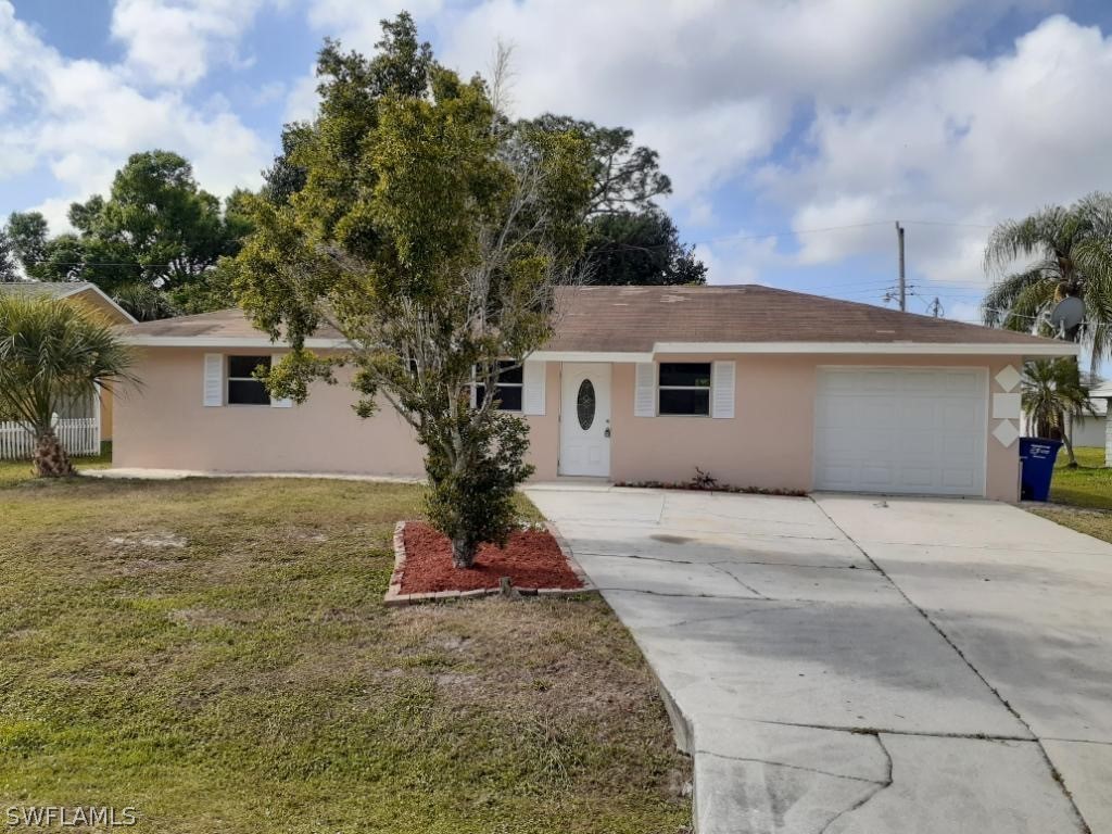19076 Coconut Road Fort Myers, FL 33967 - Photo 1 of 8 a front view of a house with a yard