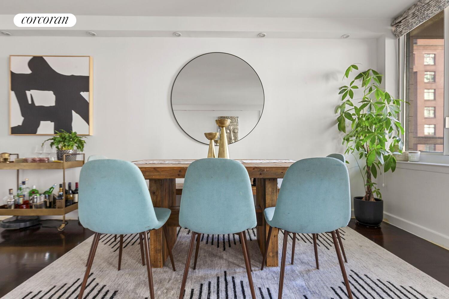 333 Rector Place, Unit 1009 Manhattan, NY 10280 - Photo 2 of 11 a view of a dining room with furniture and a potted plant