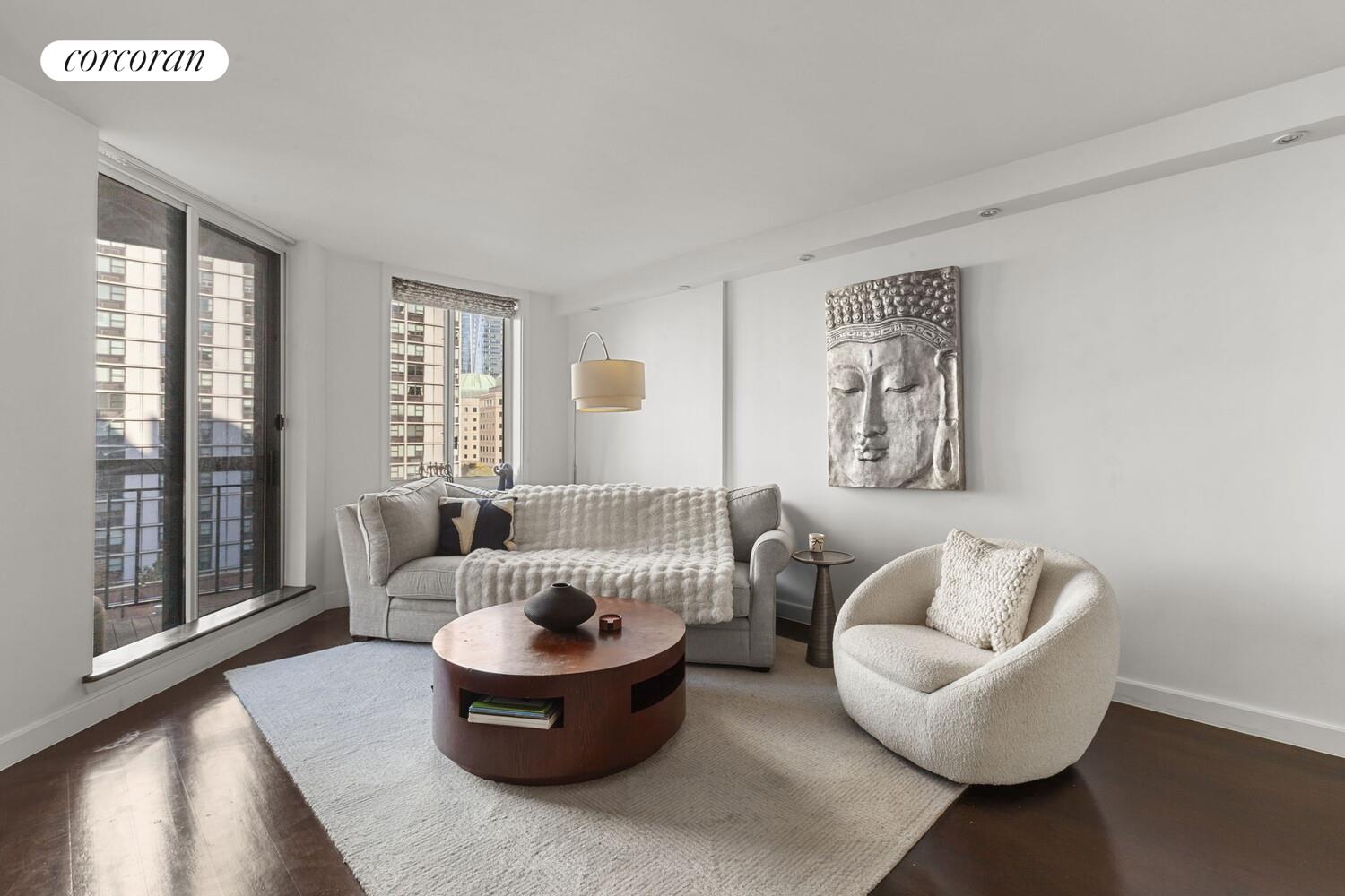 333 Rector Place, Unit 1009 Manhattan, NY 10280 - Photo 3 of 11 a living room with furniture and a large window