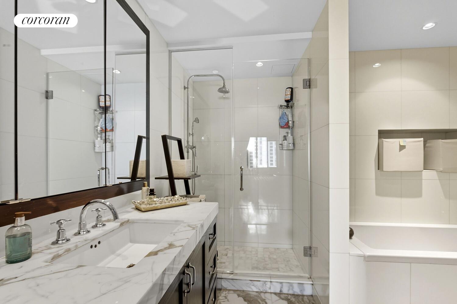 333 Rector Place, Unit 1009 Manhattan, NY 10280 - Photo 9 of 11 a bathroom with a granite countertop sink and a mirror