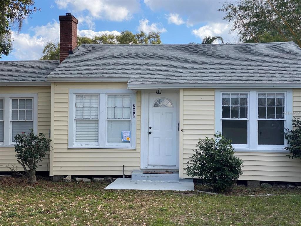 209 3rd Street Frostproof, FL 33843 - Photo 1 of 1 a front view of a house with a garden