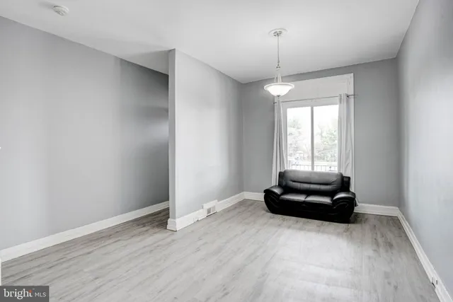 a living room with hard wood floors and a window