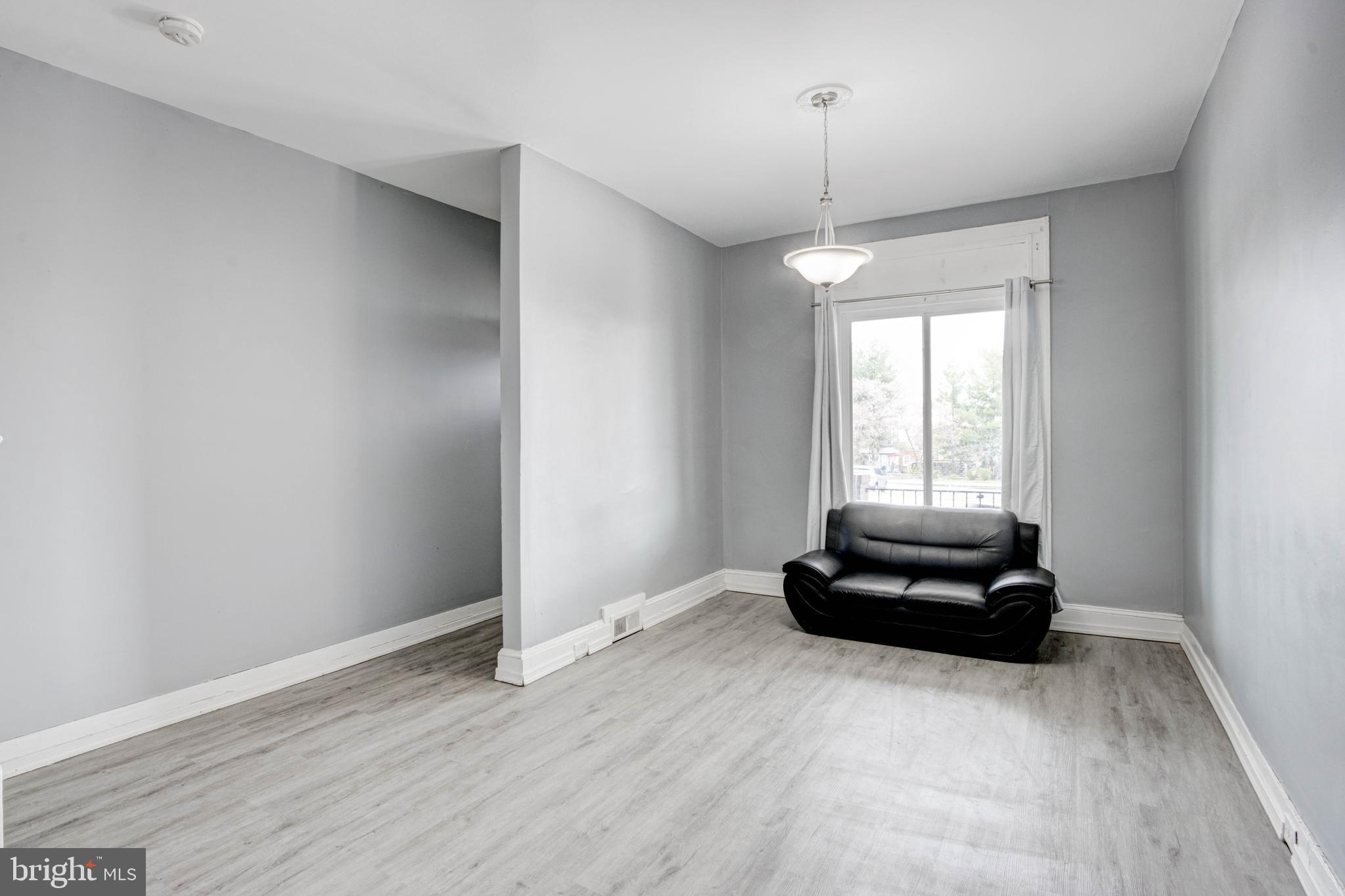 3438 Belair Road Baltimore, MD 21213 - Photo 11 of 36 a living room with hard wood floors and a window