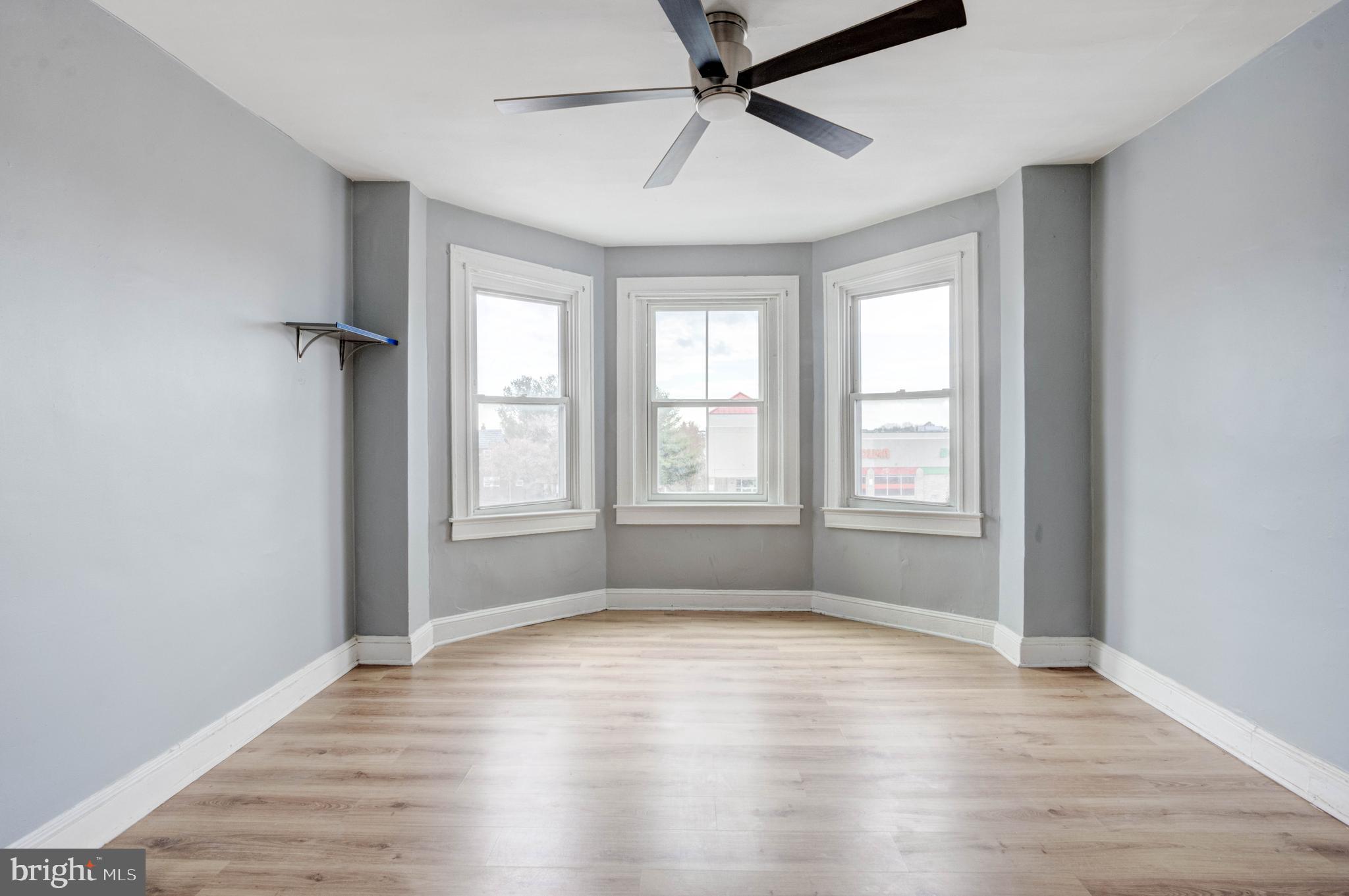 3438 Belair Road Baltimore, MD 21213 - Photo 12 of 36 wooden floor in an empty room with a window