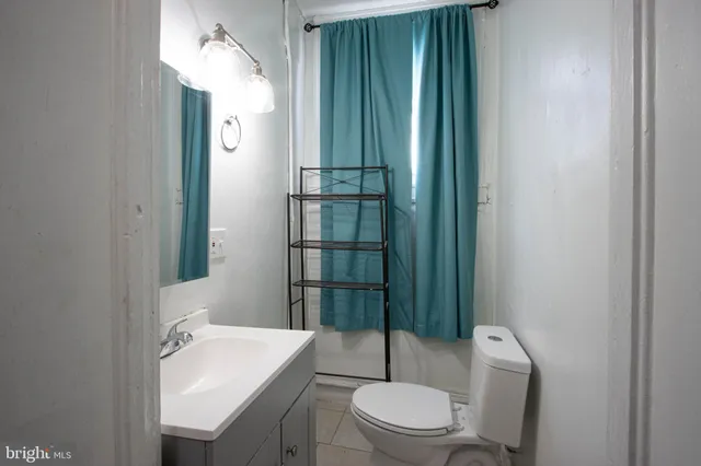 a bathroom with a toilet a sink and shower