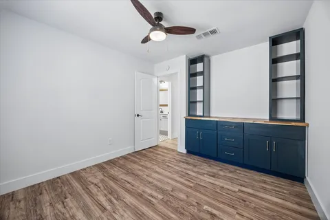 a room with a dresser and a window