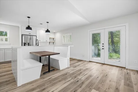 a view of a kitchen with furniture and wooden floor