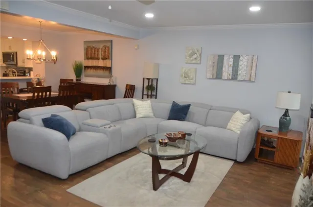 a view of a hallway with wooden floor and windows