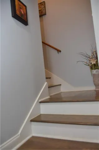 a view of staircase with white walls and a potted plant