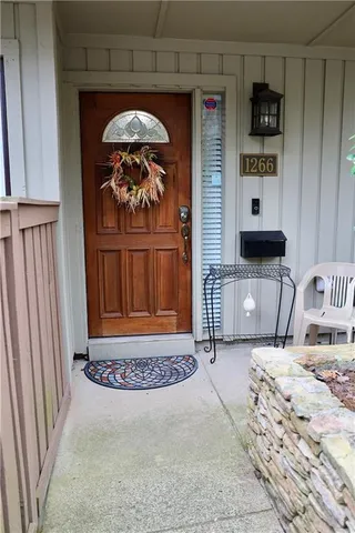 a dining room with a wooden table and chairs