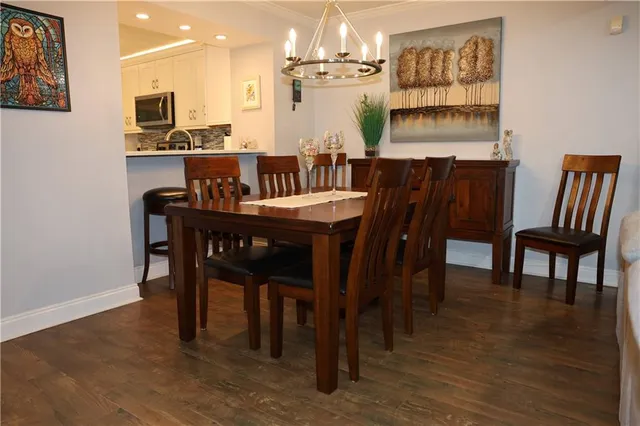 a living room with furniture kitchen view and a fireplace
