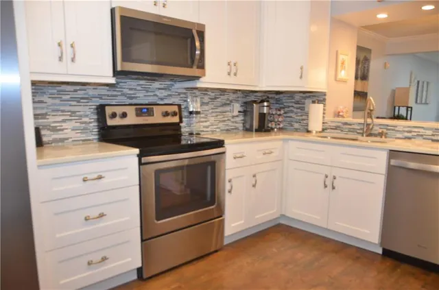 a stove top oven sitting inside of a kitchen