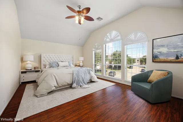 a bedroom with furniture and wooden floor
