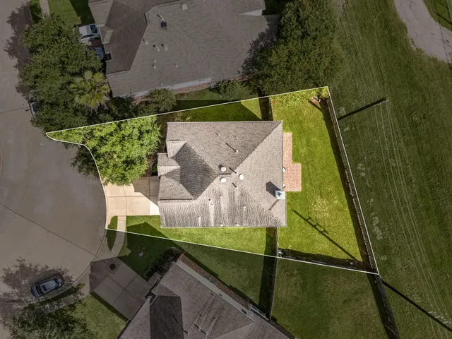 an aerial view of a house with a yard