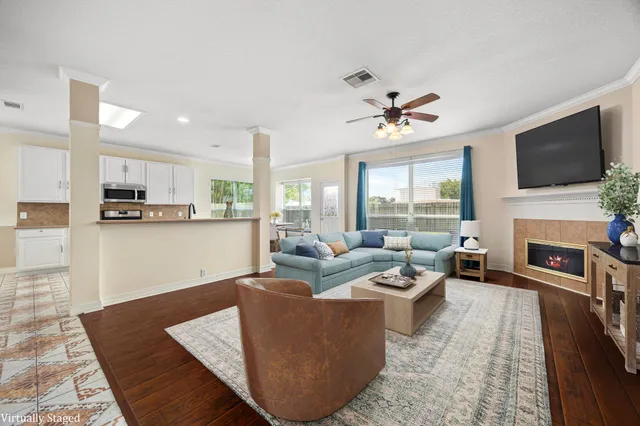 a living room with fireplace furniture and a flat screen tv