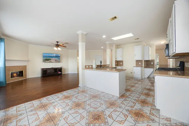 a large kitchen with a large counter top appliances and cabinets