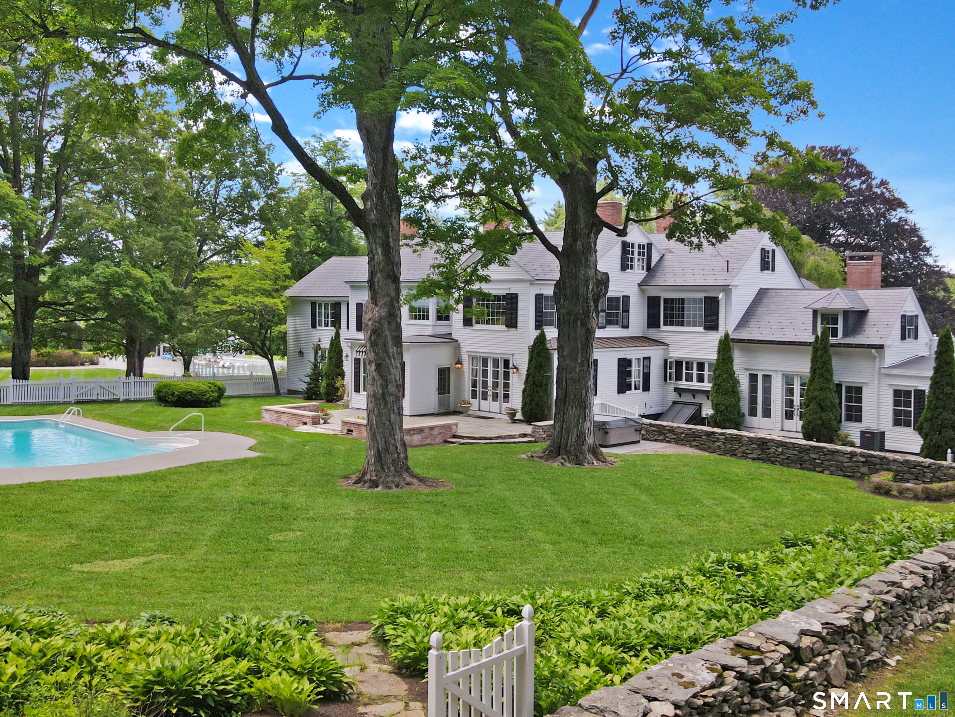433 Wrights Crossing Road Pomfret Center, CT 06259 - Photo 5 of 40 Off the back of the main house is a large lawn with an inground pool surrounded by a stonewall