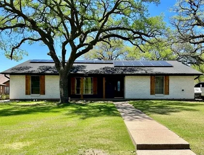 a house that has a tree in front of it