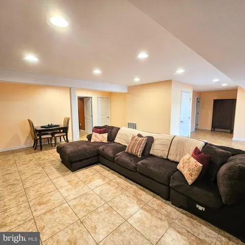 a view of a backyard with plants and a large tree