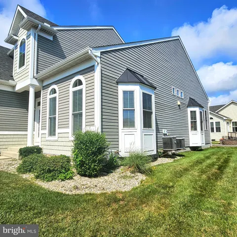 a view of a swimming pool with a lawn chairs under an umbrella