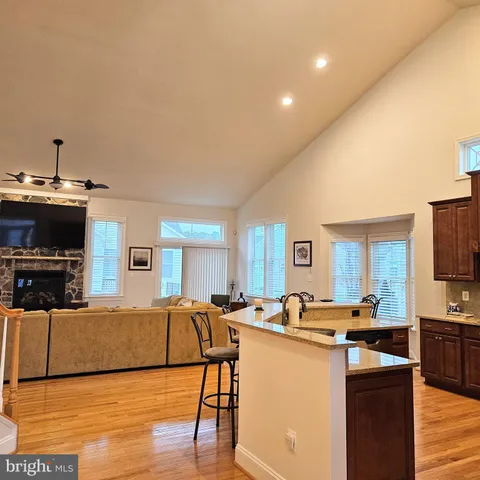 a living room with kitchen island furniture and a flat screen tv