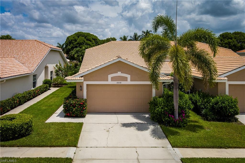 6658 Castlelawn Place, Unit 9 Naples, FL 34113 - Photo 1 of 38 Exterior featuring a neutral stucco finish, tile roof, and an attached two-car garage
