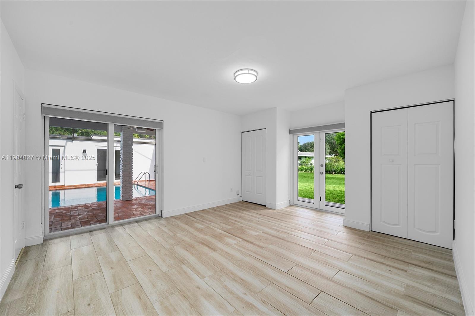 7575 Southwest 134th Street Pinecrest, FL 33156 - Photo 11 of 28 a view of an empty room with window and wooden floor