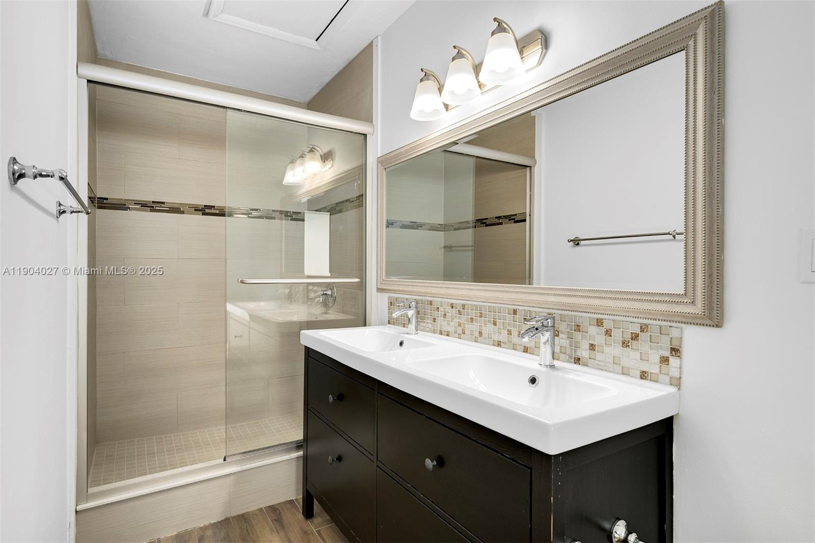 7575 Southwest 134th Street Pinecrest, FL 33156 - Photo 12 of 28 a bathroom with a sink mirror and a shower