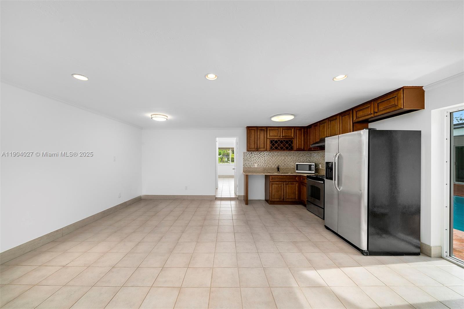 7575 Southwest 134th Street Pinecrest, FL 33156 - Photo 16 of 28 a kitchen with stainless steel appliances a refrigerator and a stove top oven