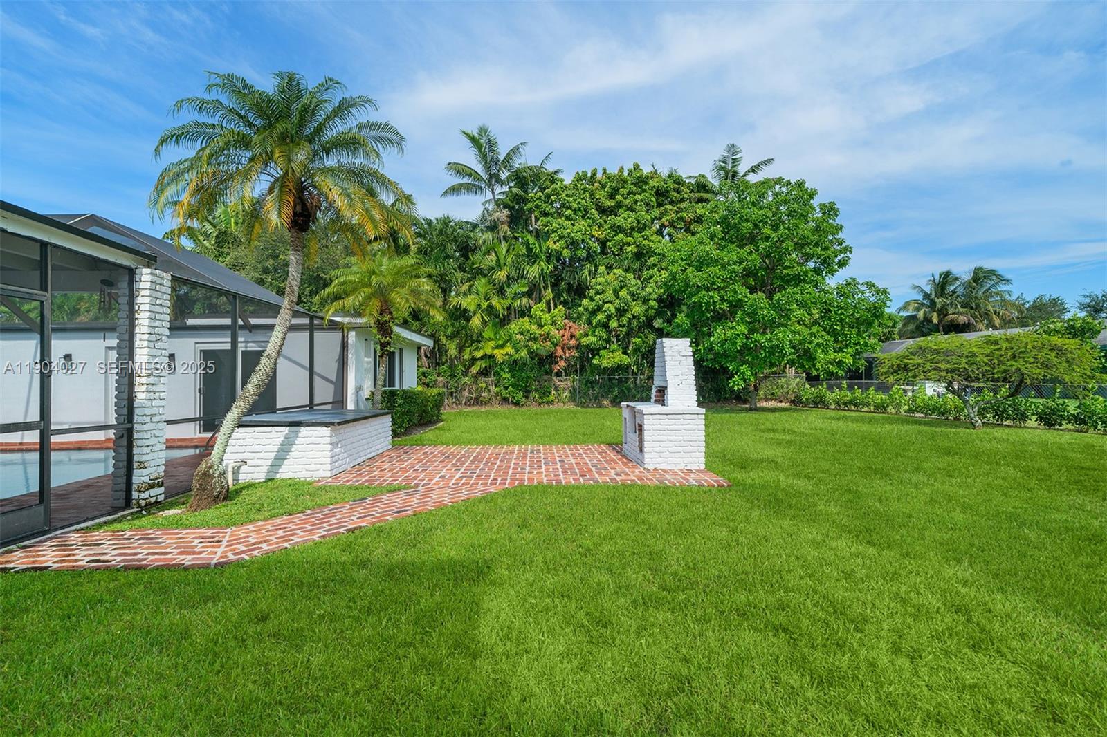 7575 Southwest 134th Street Pinecrest, FL 33156 - Photo 26 of 28 a view of a backyard with a garden and plants
