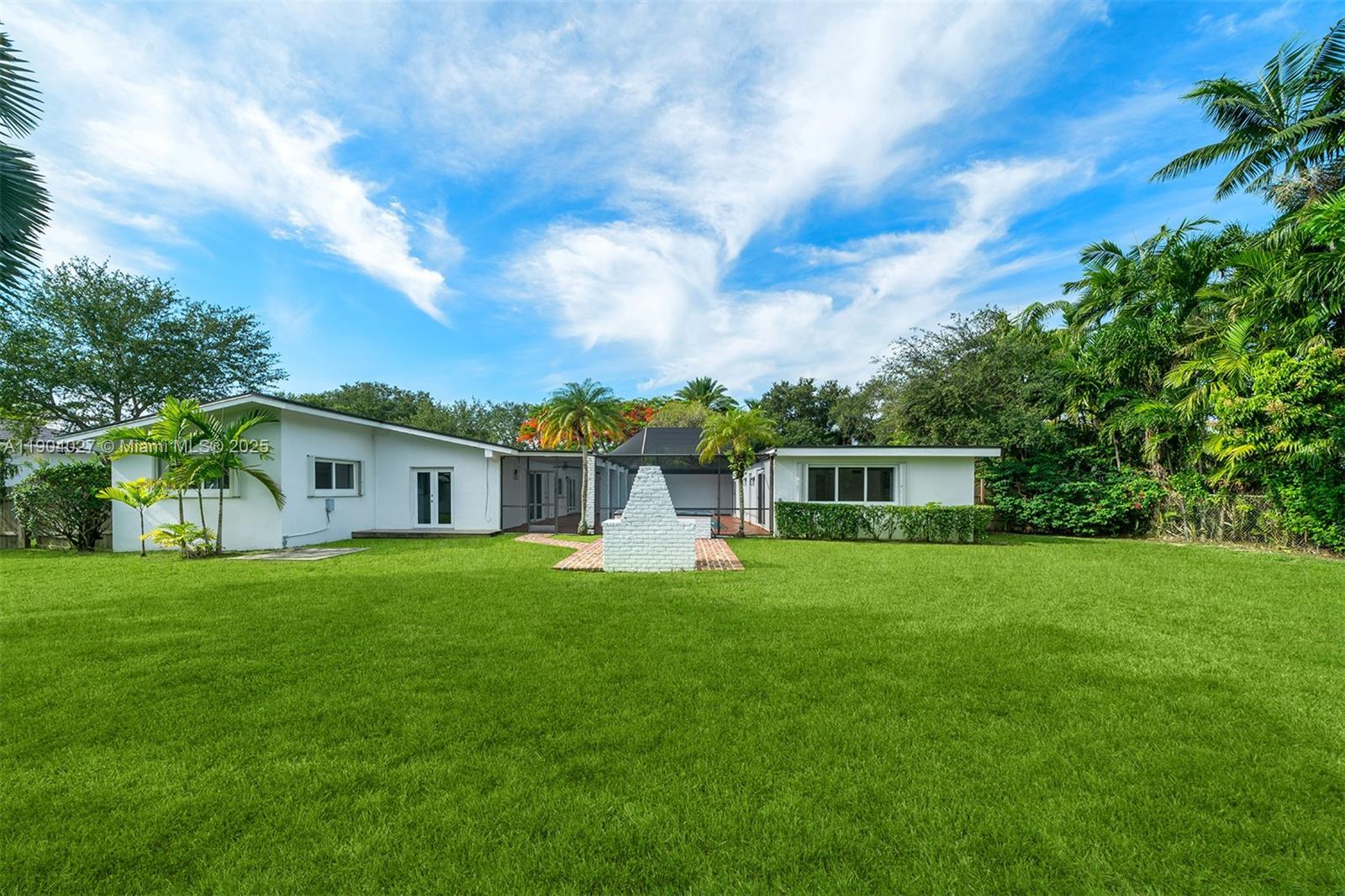 7575 Southwest 134th Street Pinecrest, FL 33156 - Photo 27 of 28 a front view of a house with a yard