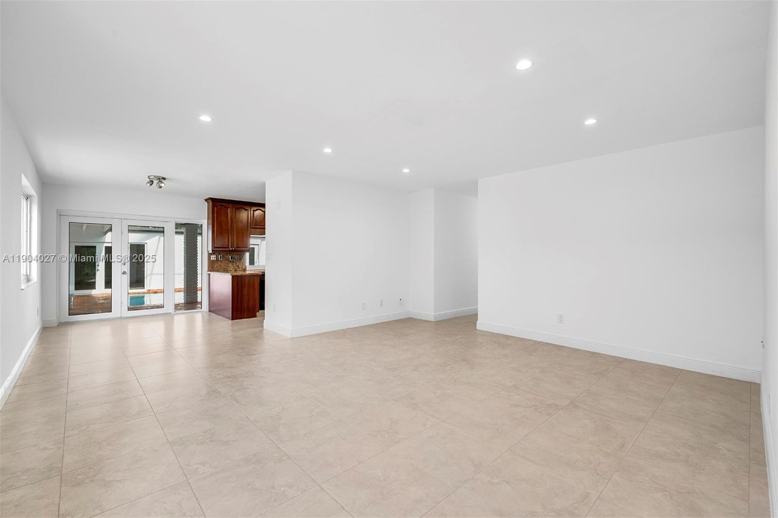 7575 Southwest 134th Street Pinecrest, FL 33156 - Photo 5 of 28 a view of an empty room with entrance and windows