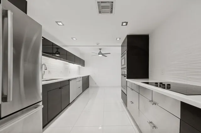 a kitchen with stainless steel appliances a refrigerator and a stove