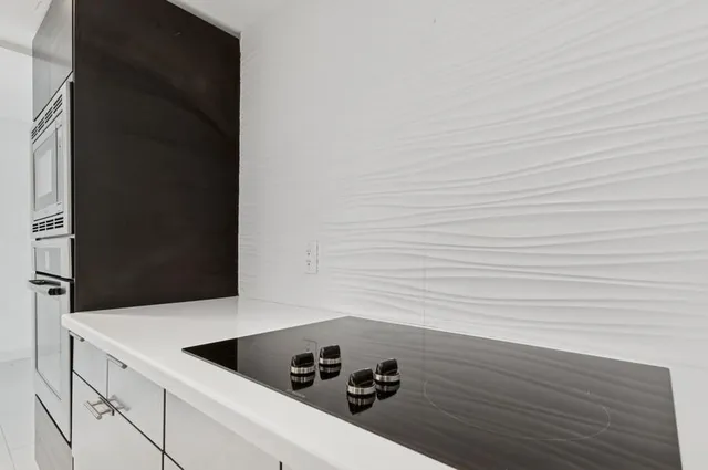 a view of a kitchen with a sink and refrigerator
