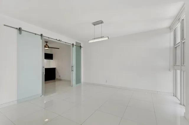 a kitchen with stainless steel appliances kitchen island granite countertop a refrigerator and a sink